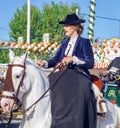Young Beautiful and Attractive Woman riding andalusian Horse Pure Spanish Horse and celebrating Seville`s April Fair Royalty Free Stock Photo