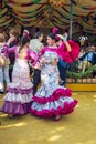 Young women wearing flamenco dresses and dancing `Sevillanas ` at the April Fair, Seville Fair