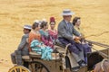 Seville, Spain - April  15, 2018: Young Women wearing traditional Sevillana dresses or flamenca dresses in a Horse drawn carriage Royalty Free Stock Photo