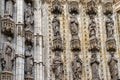 Architectural detail of the door decorations and statues of the historic cathedral in Seville