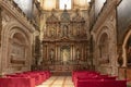 Seville, Spain - January 13, 2019: Ornate side chapel of the Virgin of Antigua with red covered pews at the Seville Cathedral