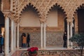 View of Patio de Maidens courtyard inside Alcazar of Seville, Spain, tourist inside
