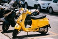 Yellow Piaggio sprint motor scooter motorbike motorcycle parked in city