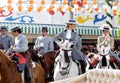 Elegant Women riding horses at the April Fair Feria de Abril, Seville Fair Feria de Sevilla