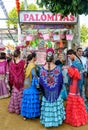 Girls wearing traditional flamenco dress and shopping sweets at the April Fair Feria de Abril, Seville Fair Feria de Sevilla Royalty Free Stock Photo