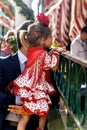 Nice and tender scene of father and daughter in traditional dress at the April Fair