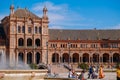 People enjoy sightseeing at the Plaza de EspaÃÂ±a. Seville, Spain.