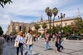 Tourists walking along the street near Seville Cathedral.