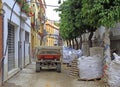 Woman is driving small excavator in the old city of Seville