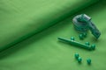 seving accessories in green tones on a fabric background Royalty Free Stock Photo