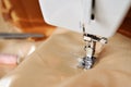 Sew fabric sewing machine in the background of scissors and thread Royalty Free Stock Photo
