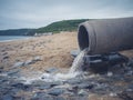 Sewage pipe on the beach Royalty Free Stock Photo