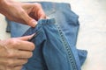 Sewed jeans by hand in the sewing workshop. Tailor`s business. Royalty Free Stock Photo