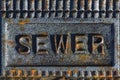 Sewer access cover with rusty iron Royalty Free Stock Photo