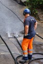 sewer cleaning and worker with water and hose in pipe