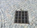 Sewer cover at paved stone