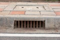 Sewer drain along road in city