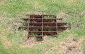 The sewer grate on the lawn - drainage for heavy rain Royalty Free Stock Photo