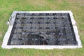 The sewer grate on the lawn - drainage for heavy rain Royalty Free Stock Photo