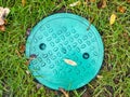 Sewer manhole in the autumn foliage Royalty Free Stock Photo