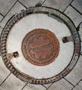 Sewer manhole cover made of metal with the inscription Budapest and the emblem of the city