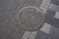 Sewer manhole on the pavement in the city of Kiev. Royalty Free Stock Photo