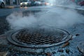 Sewer Manhole Steam Escaping on City Street, Heat Loss Concept, Urban Infrastructure, Ventilation System