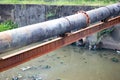 Sewer pipe over contaminated canal.