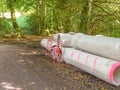 Sewer pipes on a forest road for the construction of a water drainage system Royalty Free Stock Photo