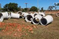 Sewer pipes laid out on the grass waiting to be installed