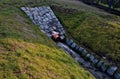 Sewer pipes under the bridge. crossing ditch by side road. concrete hole Royalty Free Stock Photo