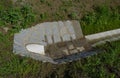 Sewer pipes under the bridge. crossing ditch by side road. concrete hole with stone paving surroundings. The gutter drains around Royalty Free Stock Photo