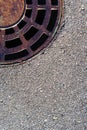 Sewer round hatch with a grate on an asphalt road. Royalty Free Stock Photo