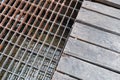 Sewer rusty steel and wood cover water drainage. Texture and background