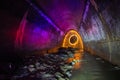 Sewer tunnel illuminated by color lanterns and freezelight