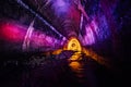 Sewer tunnel illuminated by color lanterns