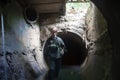 Sewer worker in underground flooded sewage collector Royalty Free Stock Photo