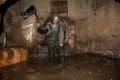 Sewer worker in underground flooded sewage collector Royalty Free Stock Photo