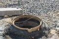 Sewerage construction with utility worker installing underground well manhole sewage Royalty Free Stock Photo