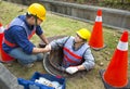 Sewerage workers in the manhole