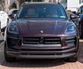 Sewickley, Pennsylvania, USA March 5, 2023 A purple Porsche SUV for sale at a dealership