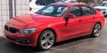 Sewickley, Pennsylvania, USA March 5, 2023 A red BMW sedan for sale at a dealership