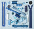 Sewing accessories on blue denim background.