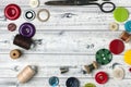 Sewing accessories on a gray table. Sewing threads, buttons and vintage scissors