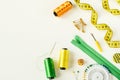 Sewing accessories for needlework in green and orange colors on a white background Royalty Free Stock Photo