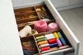 Sewing accessories in open desk drawer