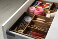 Sewing accessories in open desk drawer