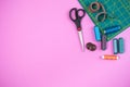 Sewing accessories on a plastic pink background. Top view, flatlay Royalty Free Stock Photo
