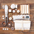 Sewing accessories in retro style on a brown wooden background.