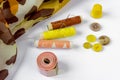 Sewing accessories: skeins of thread, buttons, fabric, thimble, needle and a centimeter on a white background Royalty Free Stock Photo